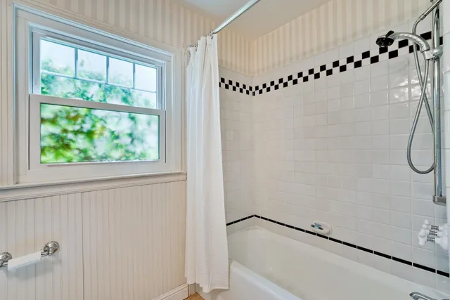 a bathroom with a shower and a window