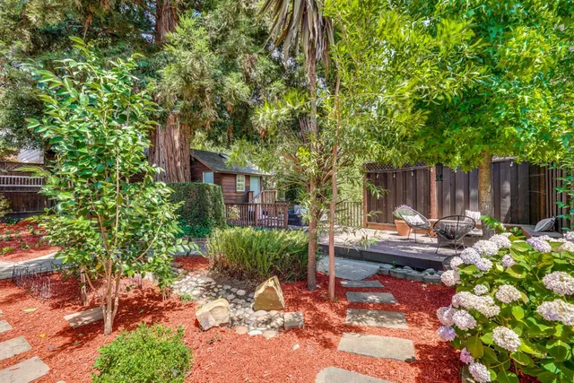 a view of backyard with seating area and green space
