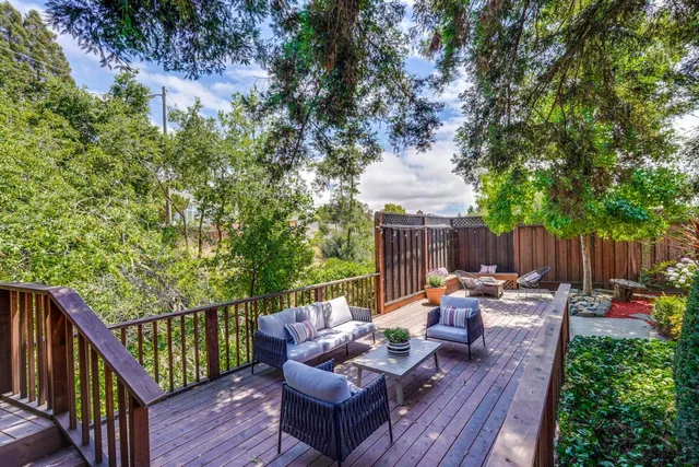 a view of a wooden deck with furniture