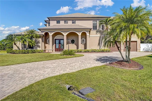 a kitchen with stainless steel appliances granite countertop a refrigerator a sink dishwasher a kitchen island with wooden cabinets and floor