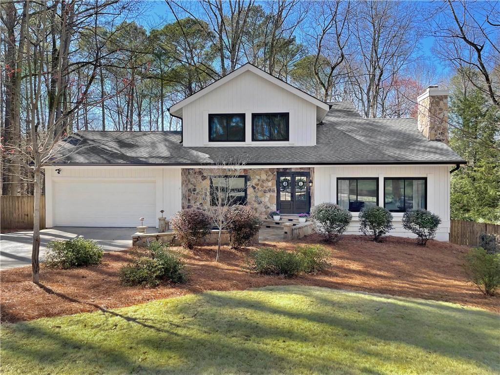 2415 Roxburgh Drive Roswell, GA 30076 - Photo 1 of 1 a front view of a house with garden and patio