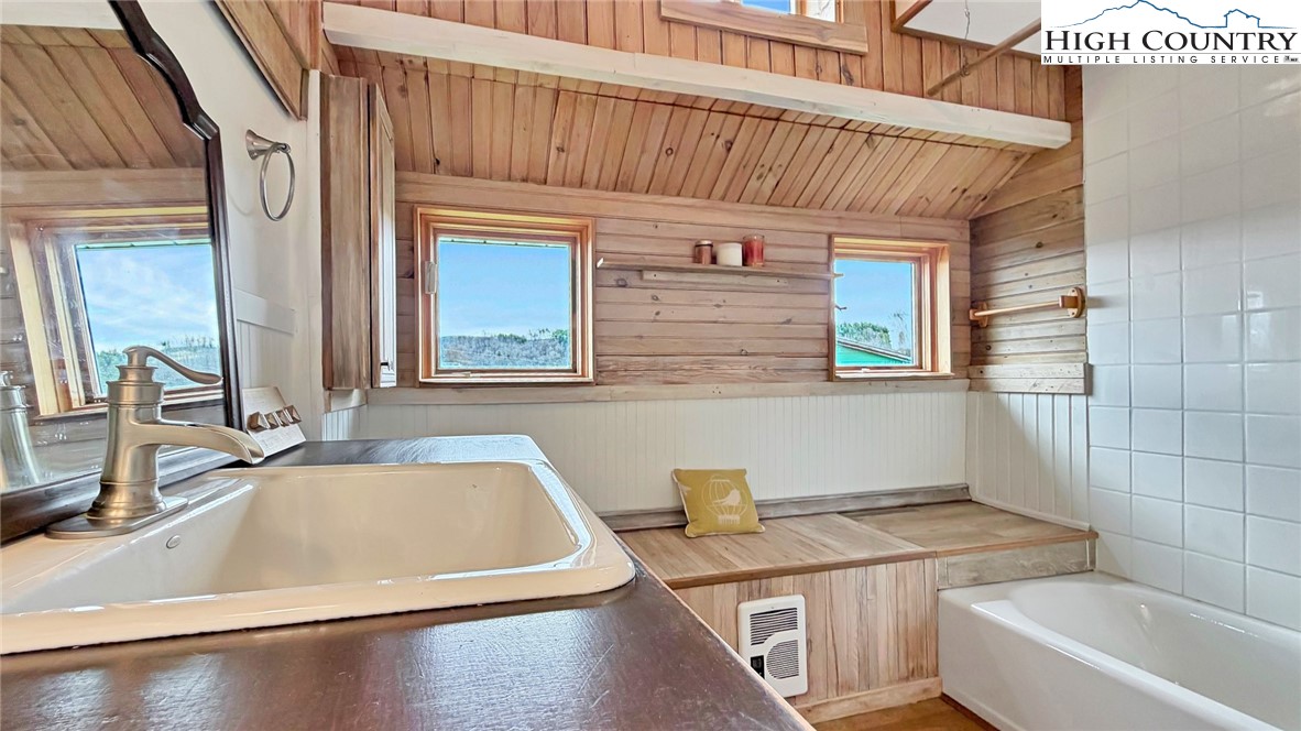 244 Flat Springs Road Elk Park, NC 28622 - Photo 11 of 25 a bathroom with a sink and a bathtub