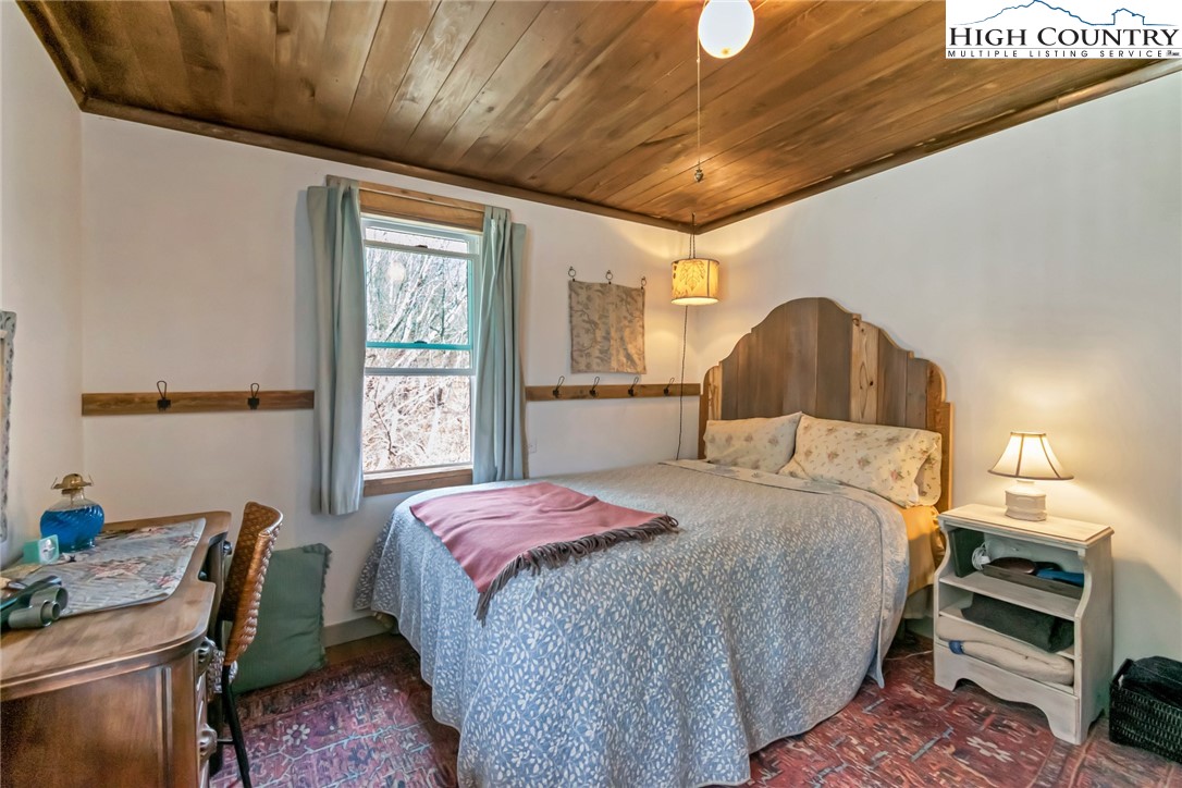 244 Flat Springs Road Elk Park, NC 28622 - Photo 13 of 25 a bedroom with a bed and a window