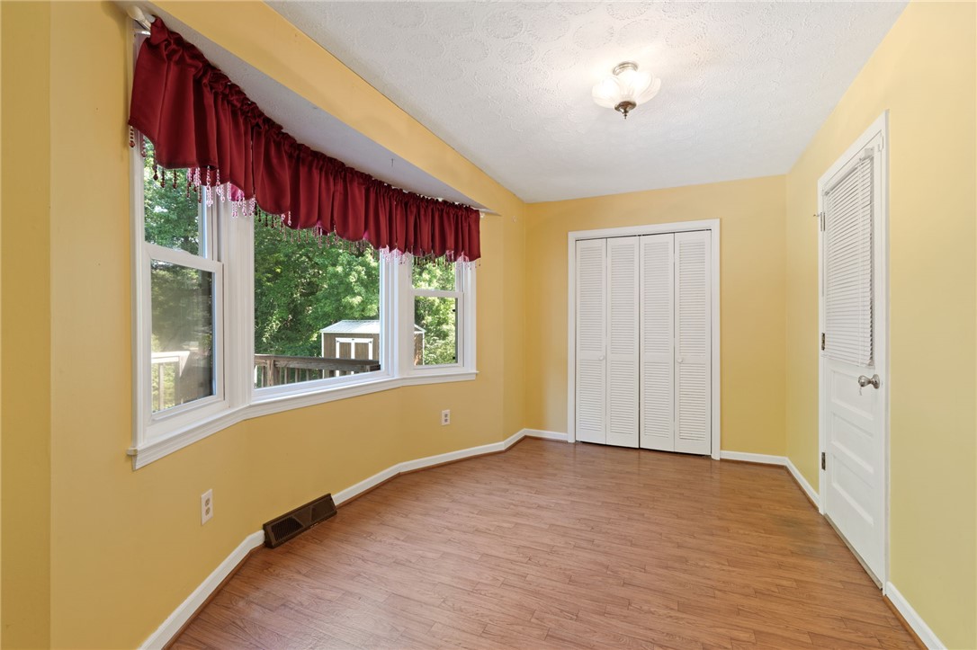 200 Echo Circle Easley, SC 29642 - Photo 20 of 35 A well-lit room with wood flooring, offering outdoor views through a wide bay window.