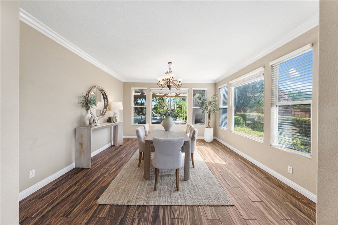 31465 Inverness Court Temecula, CA 92591 - Photo 15 of 75 Formal dining room showcases a beautiful view of the pool and cascading waterfall, creating an exceptional backdrop for dining and entertaining | Professionally Staged