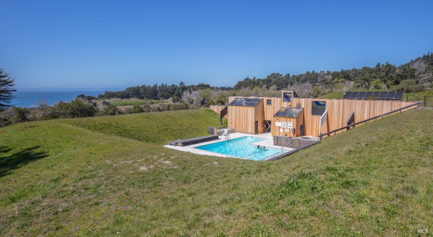 35995 Highway 1 The Sea Ranch, CA 95497 - Photo 10 of 11 a view of a swimming pool with a yard and mountain view