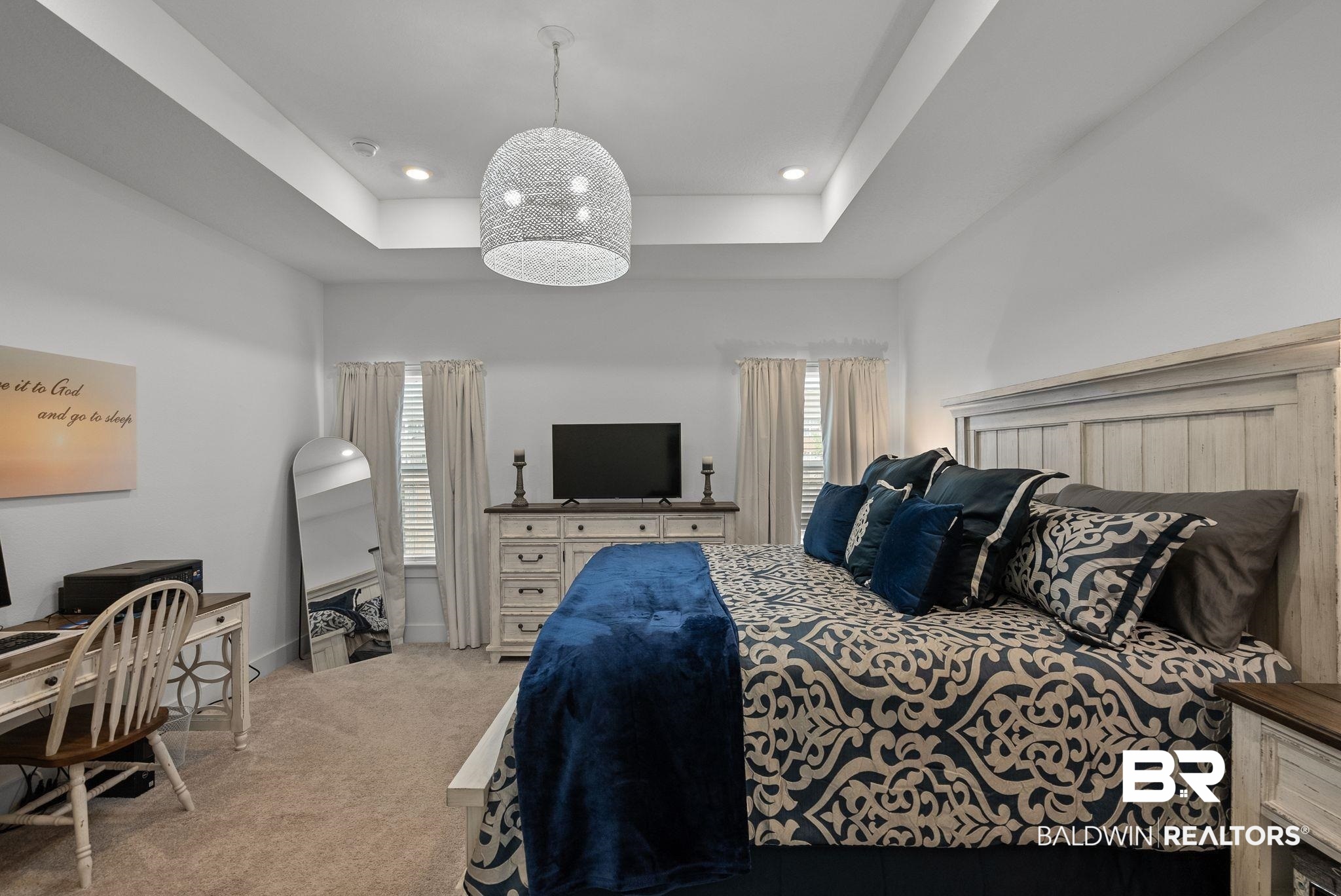 9899 Willet Way Foley, AL 36535 - Photo 18 of 37 Bedroom featuring a tray ceiling with recessed lighting and a central decorative pendant light fixture