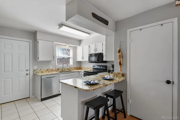 a kitchen with a stove a refrigerator and a sink