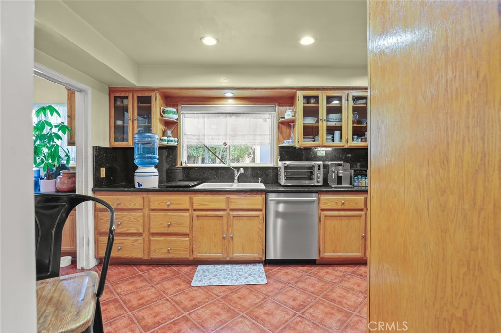 15719 Vose Street Lake Balboa, CA 91406 - Photo 14 of 41 a large white kitchen with stainless steel appliances granite countertop a stove a sink and a microwave