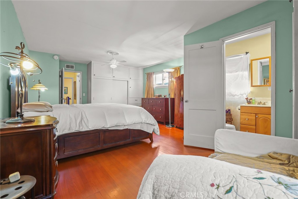 15719 Vose Street Lake Balboa, CA 91406 - Photo 20 of 41 a bedroom with a bed and wooden floor