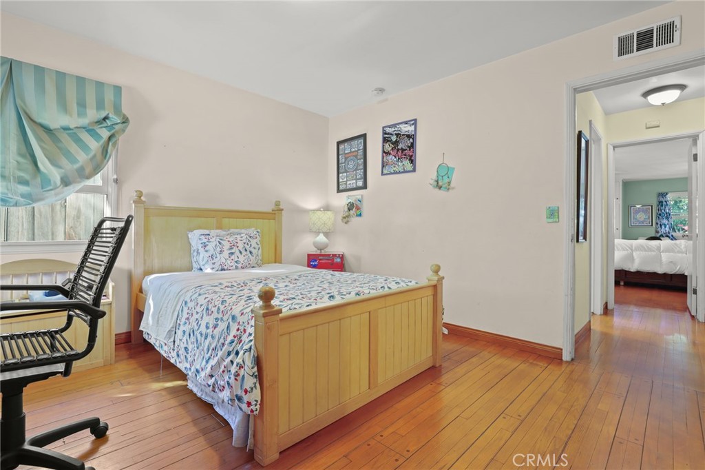 15719 Vose Street Lake Balboa, CA 91406 - Photo 23 of 41 a living room with furniture and a wooden floor