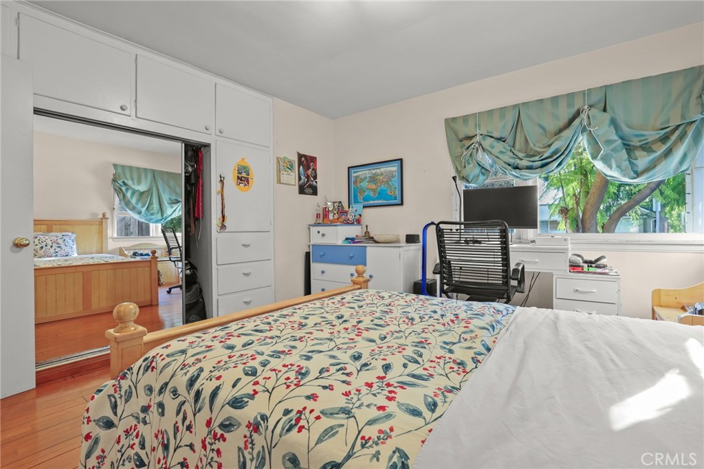 15719 Vose Street Lake Balboa, CA 91406 - Photo 24 of 41 a bedroom with a bed and a chandelier