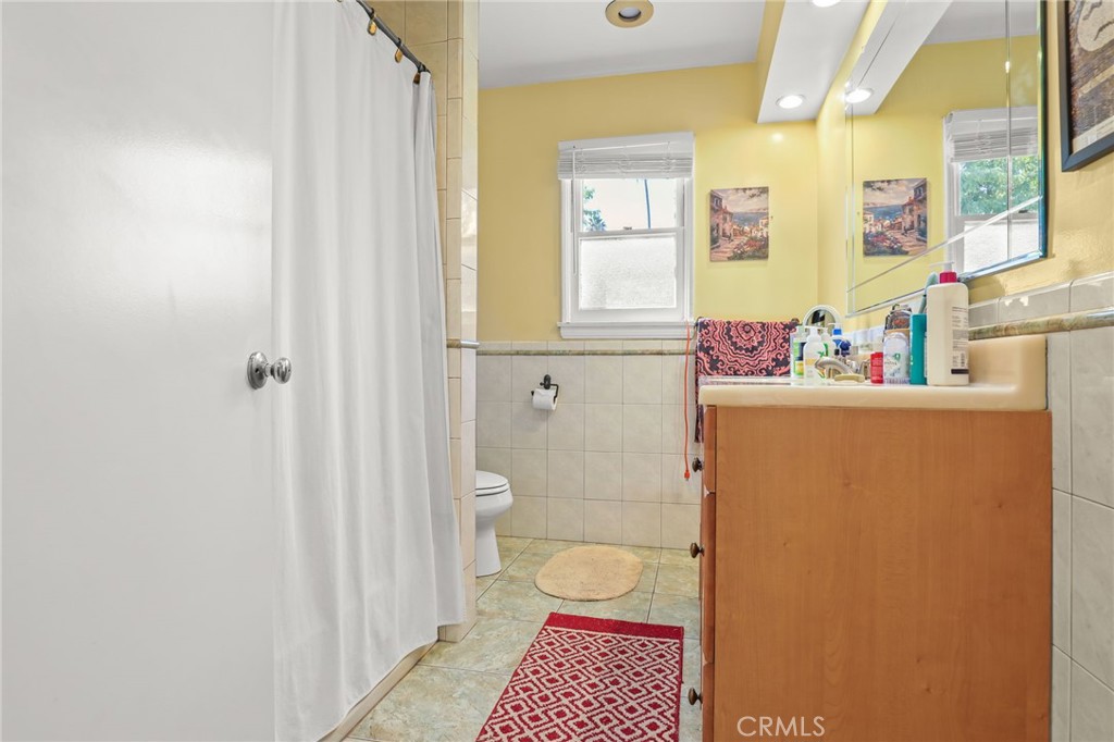 15719 Vose Street Lake Balboa, CA 91406 - Photo 25 of 41 a bathroom with a toilet and a shower