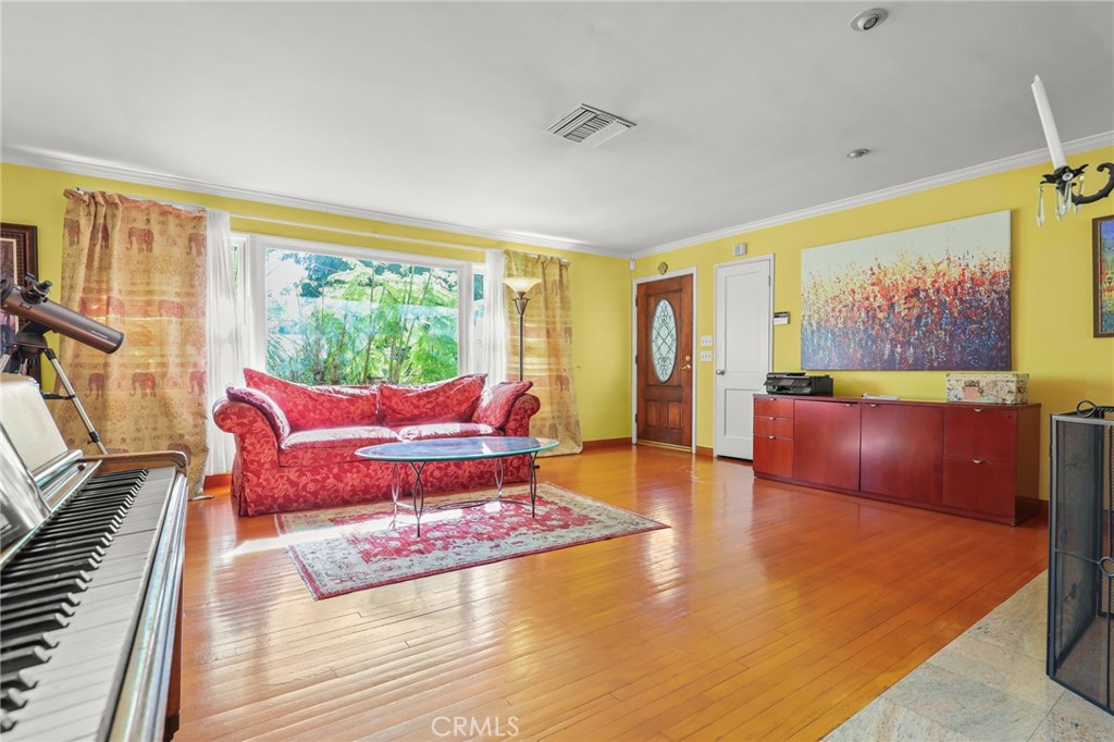 15719 Vose Street Lake Balboa, CA 91406 - Photo 8 of 41 a living room with furniture and a flat screen tv