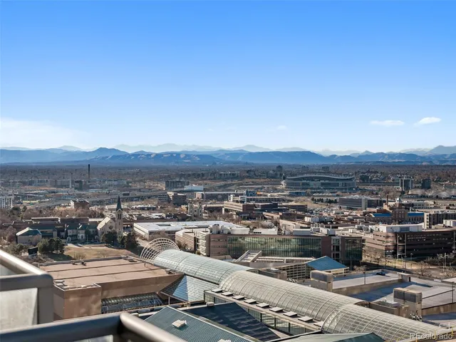 a view of a livingroom with furniture and a dining table