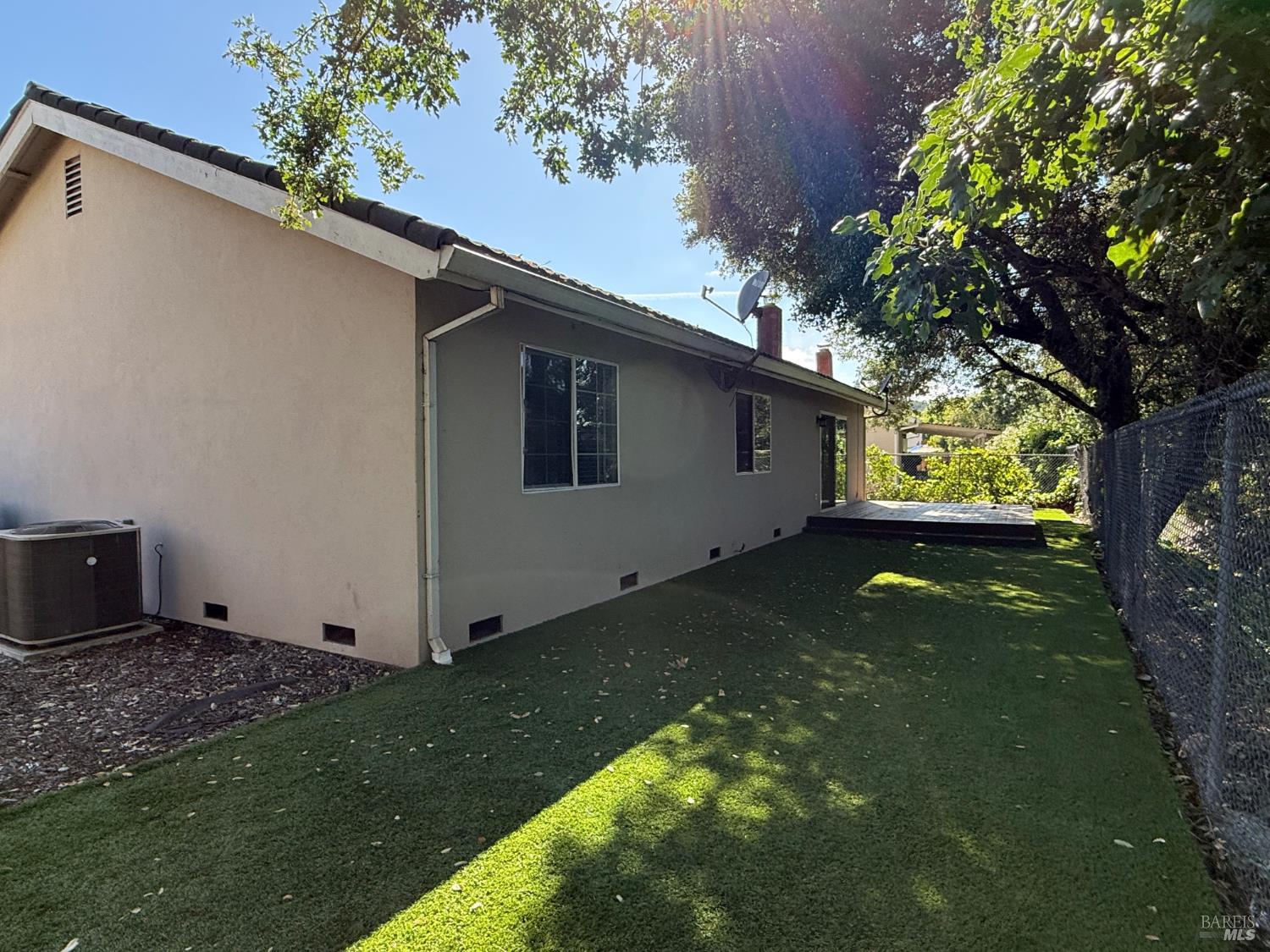 2553 Cactus Avenue Santa Rosa, CA 95405 - Photo 13 of 15 a backyard of a house with plants and large tree