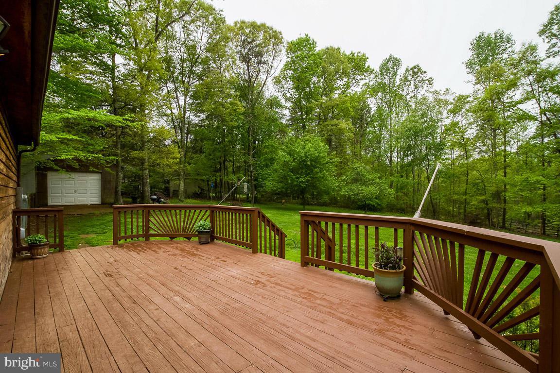 6248 Waterford Road Rixeyville, VA 22737 - Photo 14 of 15 a view of house with deck outdoor seating and trees in the background
