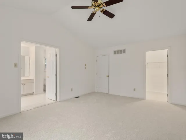 a bathroom with a tub a sink and mirror