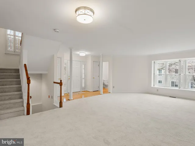 a view of an empty room with stairs