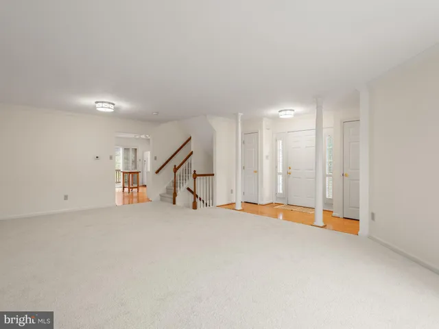 an empty room with windows and stairs