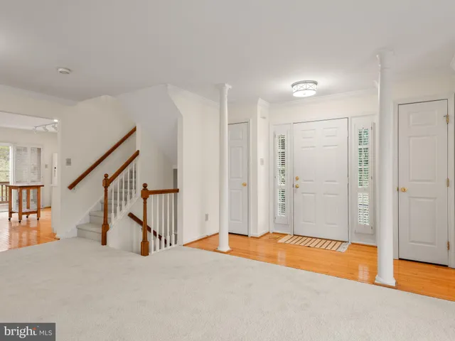 a view of an empty room with a fireplace and a window