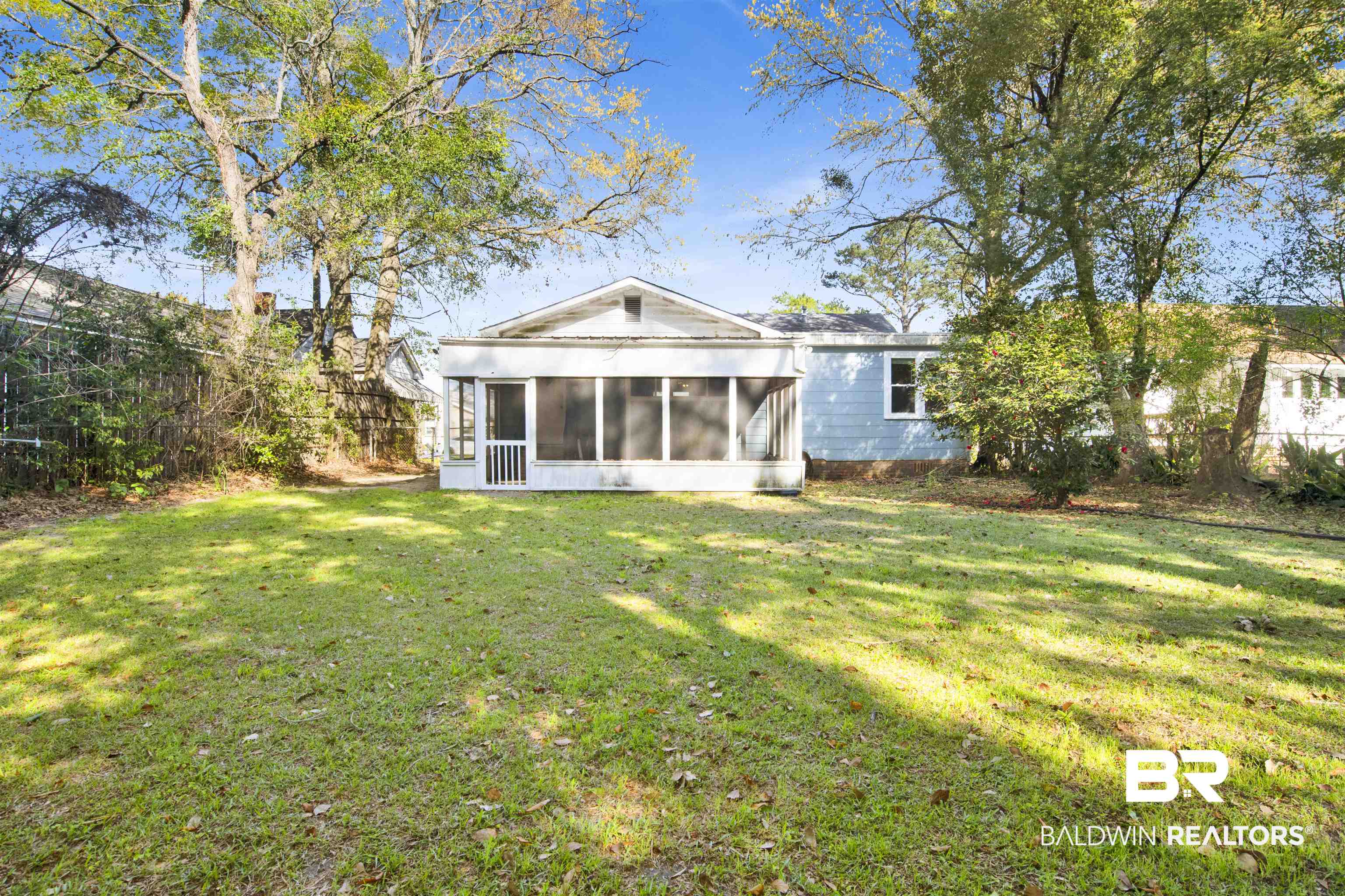 160 Emogene Place Mobile, AL 36606 - Photo 30 of 32 Back of house with a lawn and a sunroom