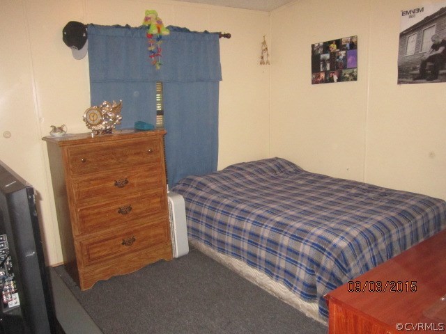 9919 Boze Road Ford, VA 23850 - Photo 10 of 12 a bedroom with a bed and a dresser