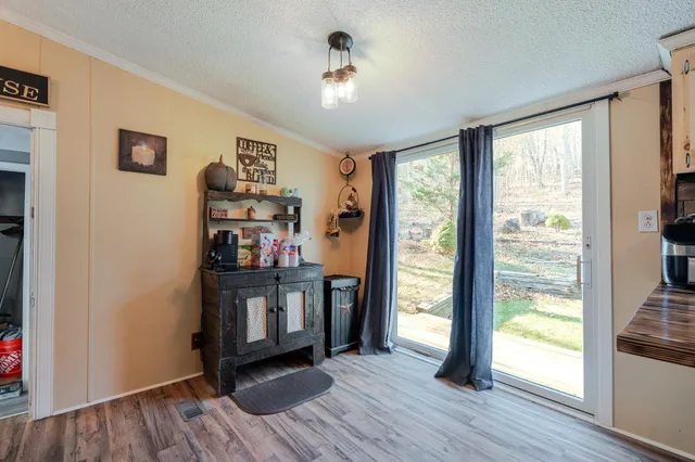 a view of a hallway with workspace and wooden floor