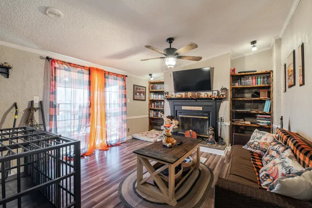a room with lots of books and furniture