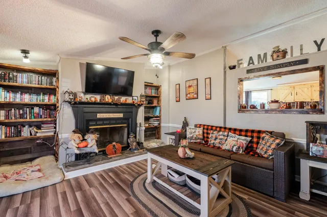 a living room with furniture and a wooden floor