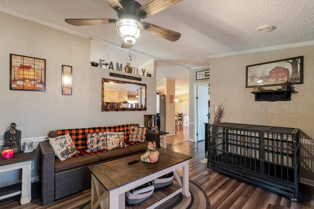 a bedroom with a bed and a flat tv screen on dresser