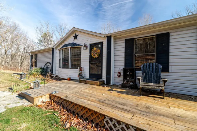 a view of a house with a yard covered with snow