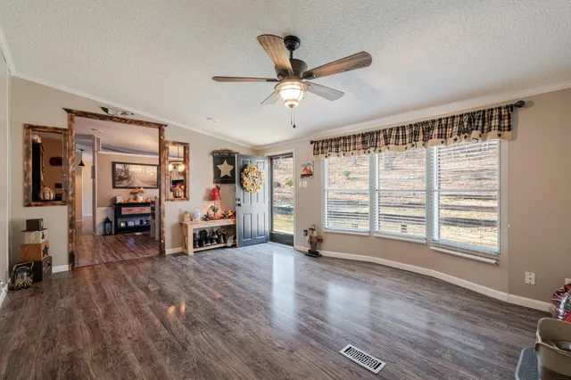 a living room with furniture and a wooden floor
