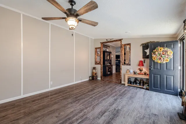 a view of a dining room with furniture a chandelier and wooden floor