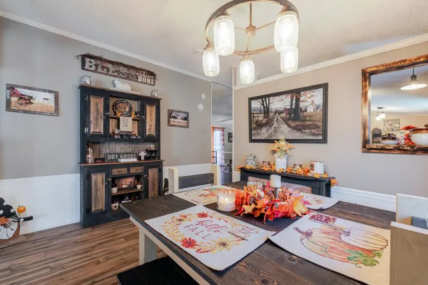 a kitchen with wooden floors and appliances