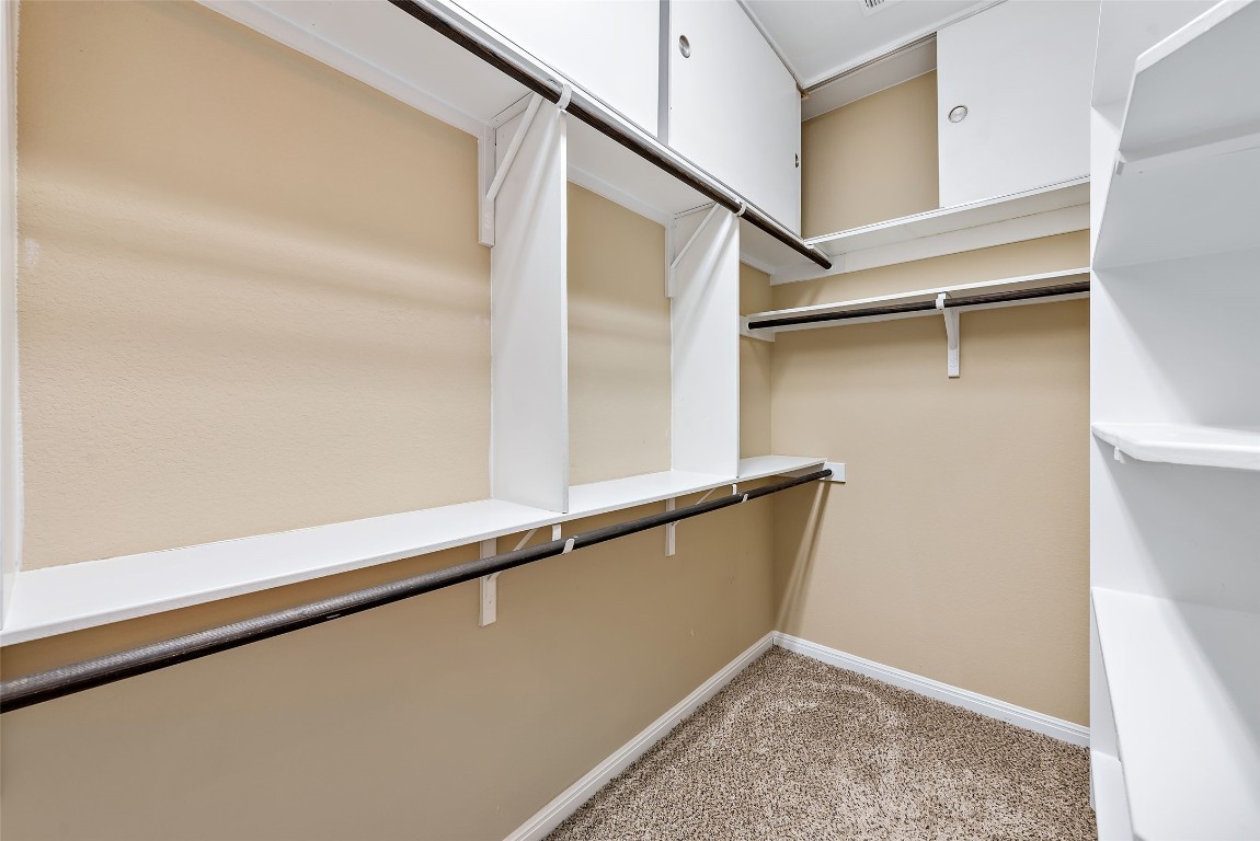 2000 Manada Trail Leander, TX 78641 - Photo 24 of 36 Functional custom shelving and rods maximize storage in this well-appointed walk-in closet.