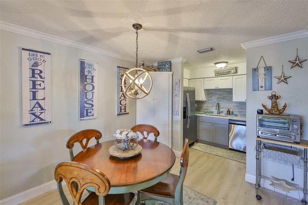 1041 Apollo Beach Boulevard, Unit F Apollo Beach, FL 33572 - Photo 15 of 35 a view of dining room and kitchen island with furniture