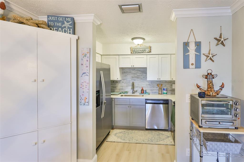 1041 Apollo Beach Boulevard, Unit F Apollo Beach, FL 33572 - Photo 17 of 35 a kitchen with stainless steel appliances a refrigerator and a stove
