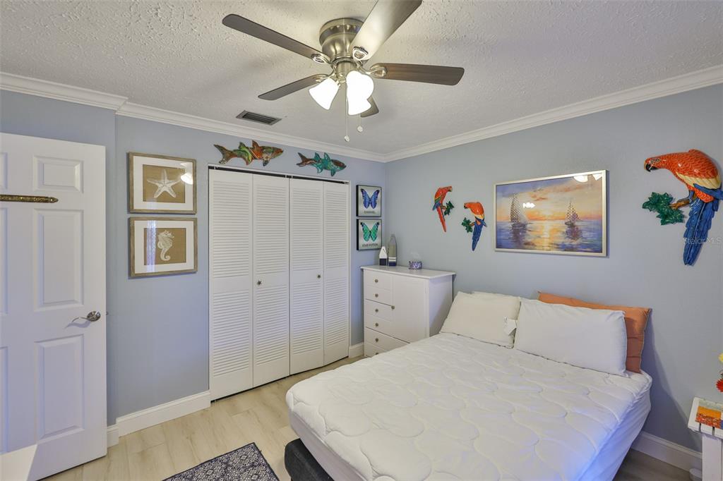 1041 Apollo Beach Boulevard, Unit F Apollo Beach, FL 33572 - Photo 22 of 35 a bedroom with a large bed and a chandelier