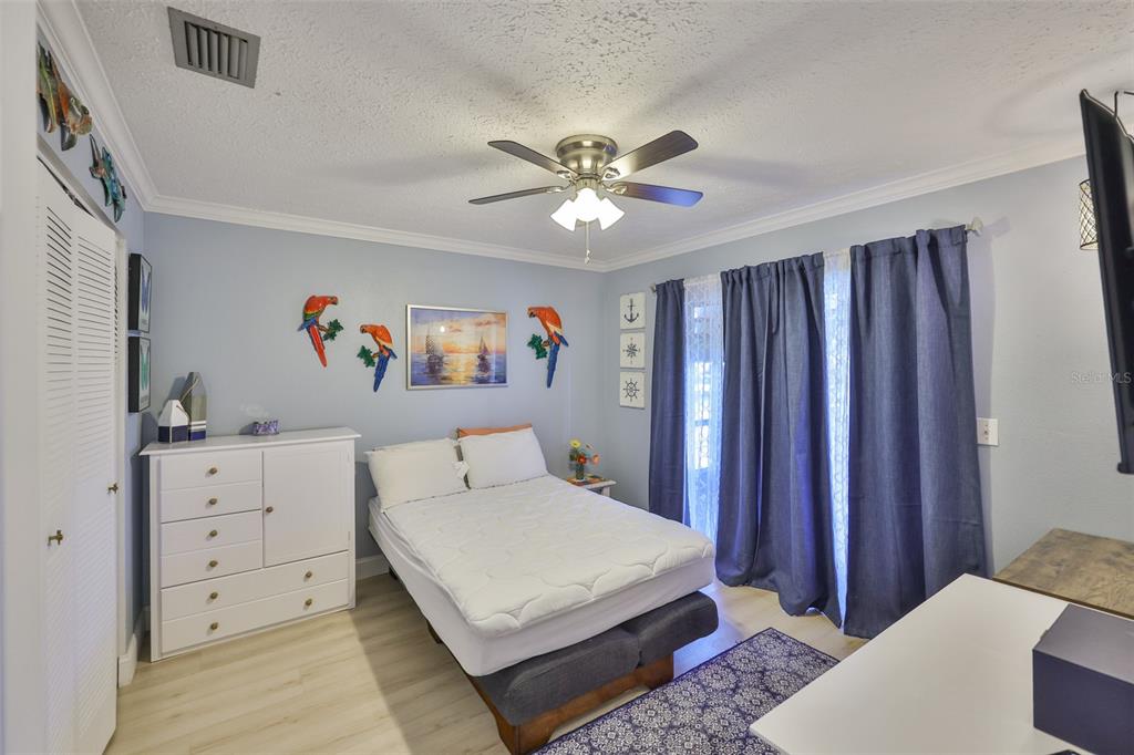 1041 Apollo Beach Boulevard, Unit F Apollo Beach, FL 33572 - Photo 23 of 35 a bedroom with a bed and a chandelier