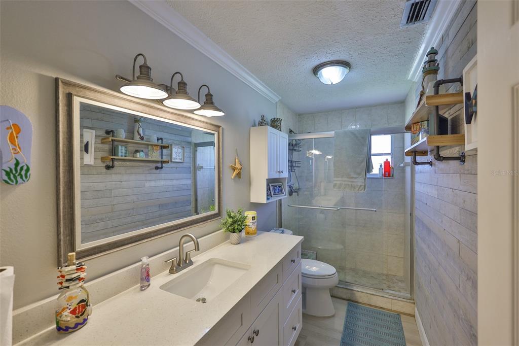 1041 Apollo Beach Boulevard, Unit F Apollo Beach, FL 33572 - Photo 24 of 35 a bathroom with a sink a toilet and shower
