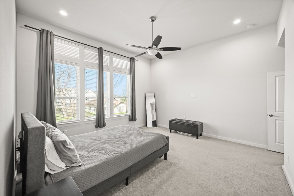 4002 Elser Street Houston, TX 77009 - Photo 16 of 36 a bedroom with a bed and a chandelier