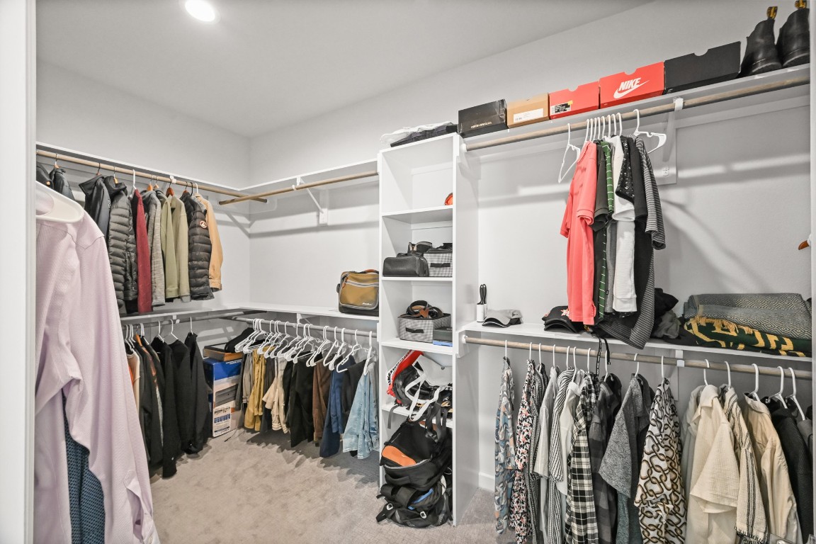 4002 Elser Street Houston, TX 77009 - Photo 21 of 36 a view of walk in closet with clothes and shoes