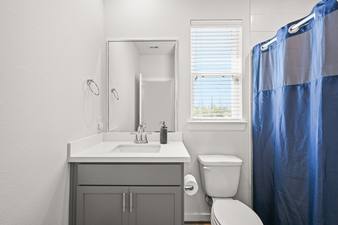 4002 Elser Street Houston, TX 77009 - Photo 24 of 36 a bathroom with a toilet sink vanity and mirror