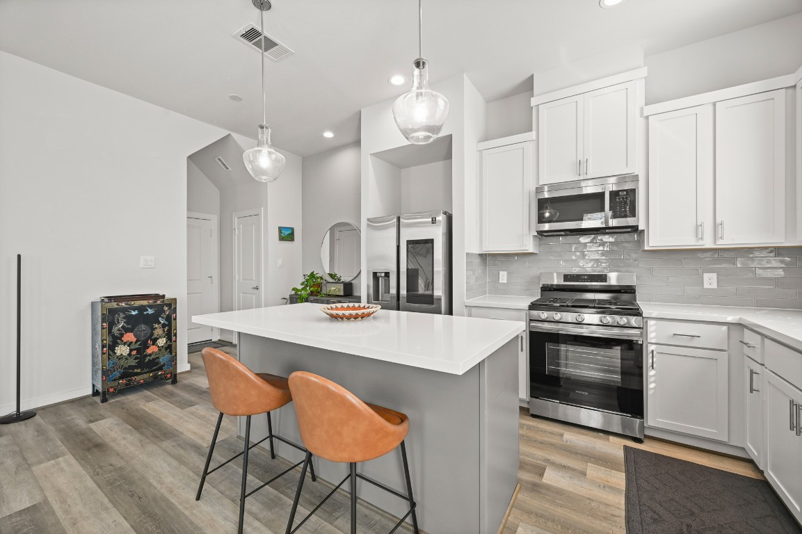 4002 Elser Street Houston, TX 77009 - Photo 4 of 36 a kitchen with stainless steel appliances a stove a sink a microwave a refrigerator and cabinets
