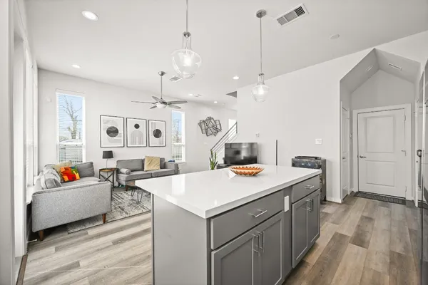 a view of a kitchen center island and living room