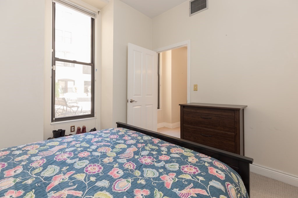 4 Charlesgate East, Unit 107 Boston, MA 02215 - Photo 11 of 12 a bedroom with a bed and a window