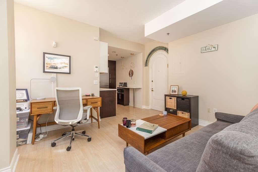 4 Charlesgate East, Unit 107 Boston, MA 02215 - Photo 2 of 12 a living room with furniture a rug and white walls