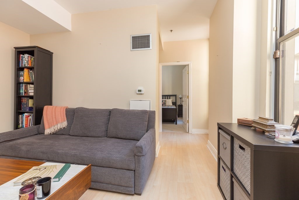 4 Charlesgate East, Unit 107 Boston, MA 02215 - Photo 3 of 12 a living room with furniture and wooden floor