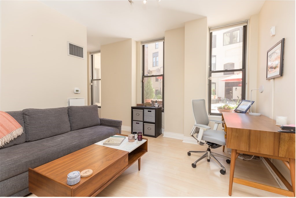 4 Charlesgate East, Unit 107 Boston, MA 02215 - Photo 5 of 12 a living room with furniture and a window